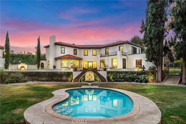 1205 W Highland Ave, Redlands, CA 92373 - rear view of house with stairs, a tile roof, a chimney, stucco siding, and a balcony