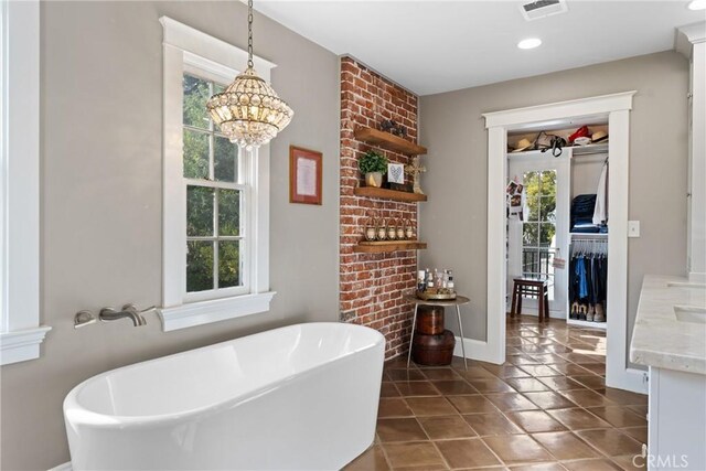 1205 W Highland Ave, Redlands, CA 92373 - bathroom featuring plenty of natural light, a soaking tub, a chandelier, tile patterned floors, and recessed lighting