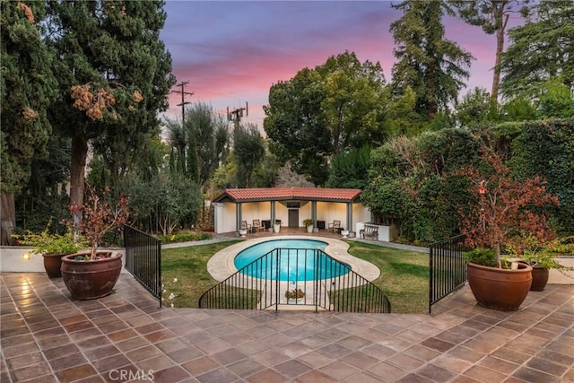 1205 W Highland Ave, Redlands, CA 92373 - pool at dusk with a patio and an outdoor structure