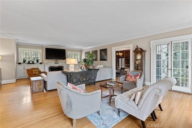 1205 W Highland Ave, Redlands, CA 92373 - living area with light wood-type flooring, plenty of natural light, ornamental molding, baseboards, and a fireplace