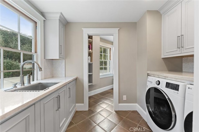 1205 W Highland Ave, Redlands, CA 92373 - washroom featuring separate washer and dryer, cabinet space, plenty of natural light, and baseboards