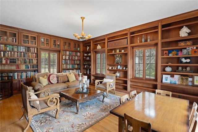 1205 W Highland Ave, Redlands, CA 92373 - living room with a chandelier, wood finished floors, and bookshelves
