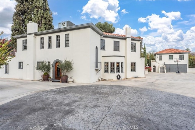 1205 W Highland Ave, Redlands, CA 92373 - view of front of house with a chimney, stucco siding, and a tile roof