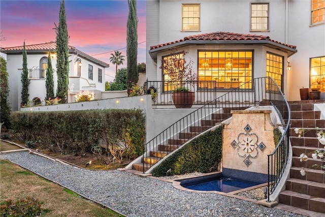 1205 W Highland Ave, Redlands, CA 92373 - view of front of property featuring stairway, stucco siding, and a tile roof