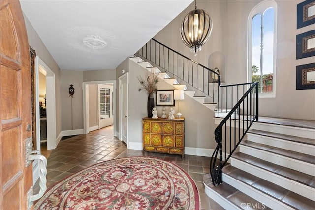 1205 W Highland Ave, Redlands, CA 92373 - foyer with stairway, tile patterned flooring, and baseboards