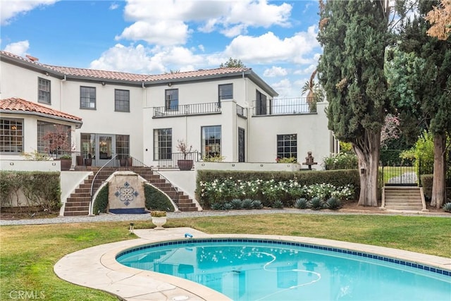 1205 W Highland Ave, Redlands, CA 92373 - back of house with stairway, a balcony, a lawn, stucco siding, and a tiled roof