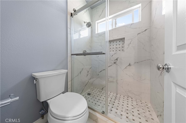 full bath with a textured wall, a marble finish shower, and toilet