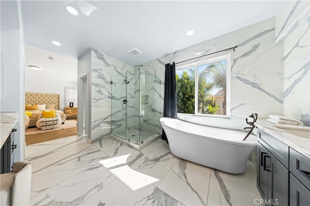 ensuite bathroom with marble finish floor, stone wall, visible vents, and ensuite bathroom