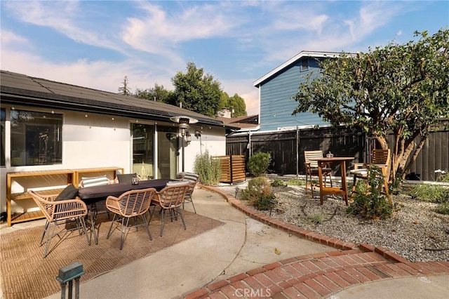 back of house with a patio area and solar panels