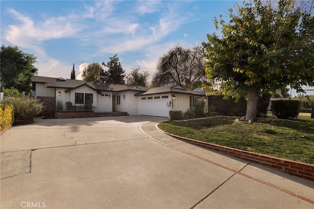 single story home featuring a front lawn and a garage