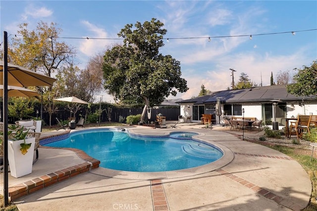 view of swimming pool featuring a patio and an in ground hot tub