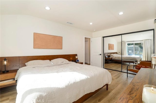 bedroom with hardwood / wood-style flooring and a closet