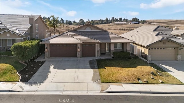 view of front of home featuring a garage, driveway, and a tiled roof