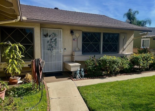 property entrance with a lawn