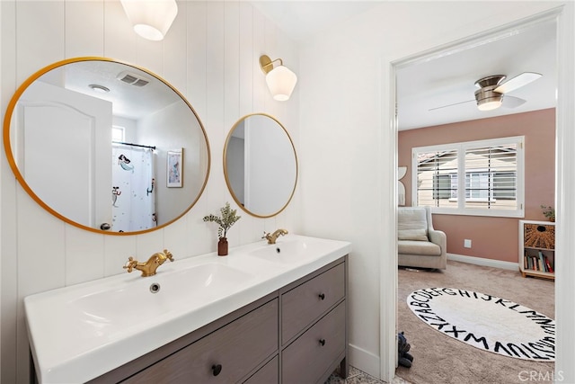 full bath featuring double vanity, a sink, visible vents, and a ceiling fan