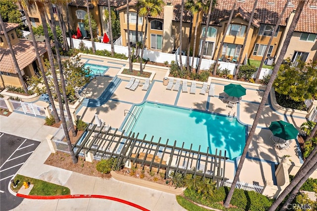 view of swimming pool featuring a residential view and fence