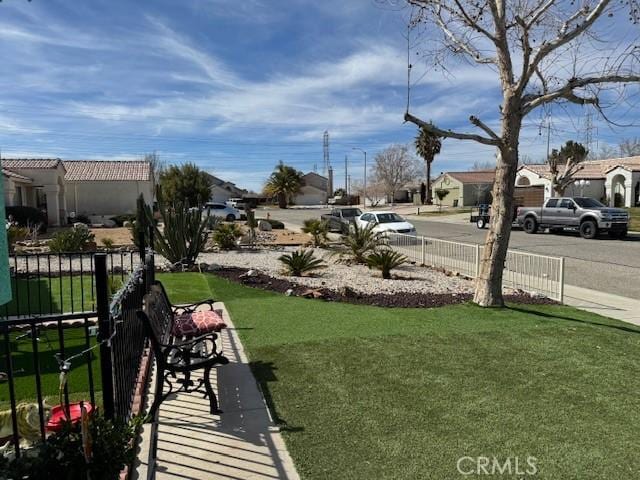 view of yard featuring a residential view and fence