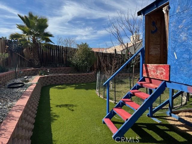 view of playground featuring fence