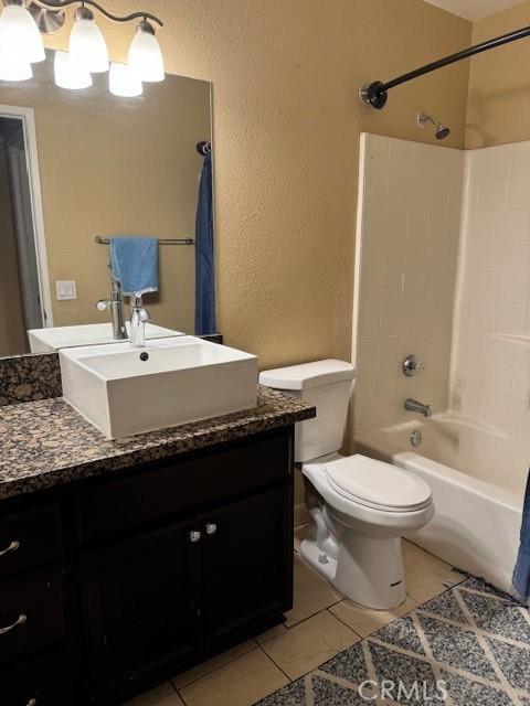 bathroom with vanity, tile patterned flooring, and toilet