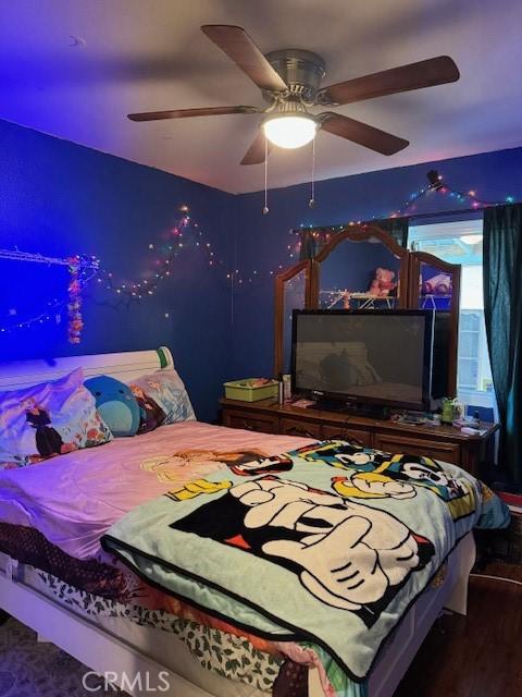 bedroom with a ceiling fan and wood finished floors