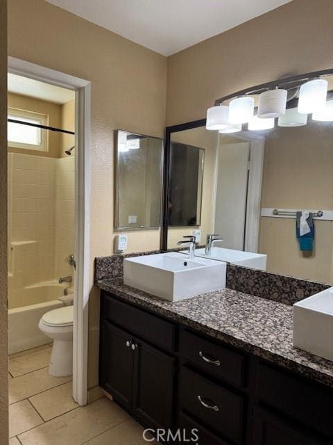 bathroom with tile patterned flooring, tub / shower combination, vanity, and toilet