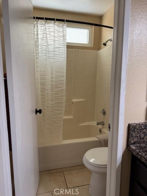 bathroom with tile patterned flooring, shower / tub combo with curtain, vanity, and toilet