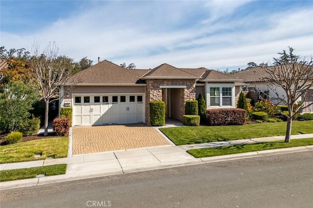 view of front of home featuring a garage and a front lawn