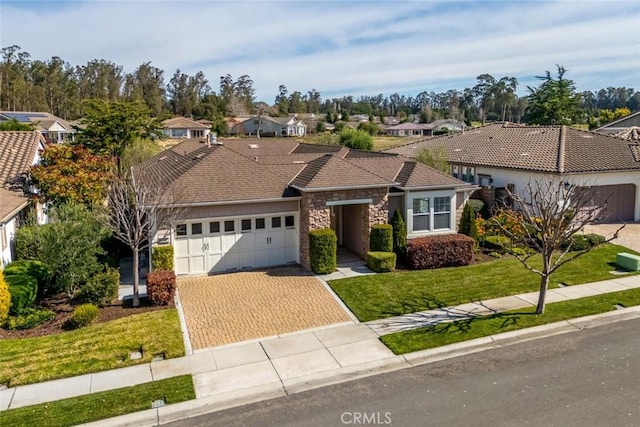 view of front of property featuring a garage and a front lawn