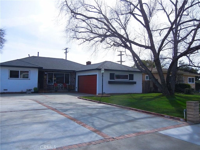 ranch-style house with a front yard and a garage