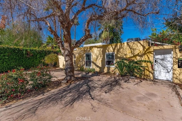 view of front of home with fence and stucco siding