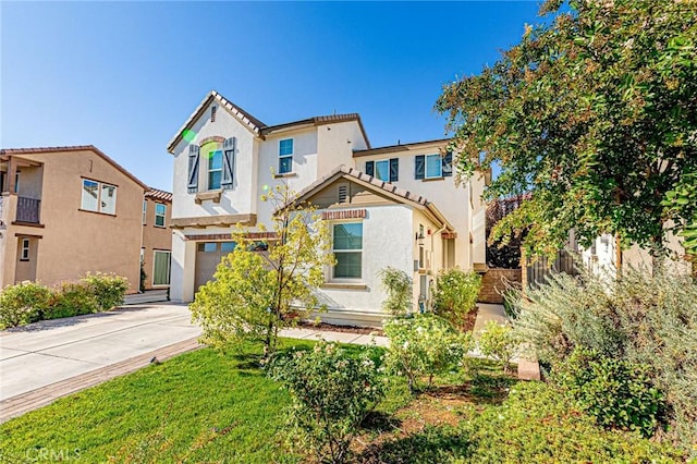 mediterranean / spanish-style house with a front lawn and a garage