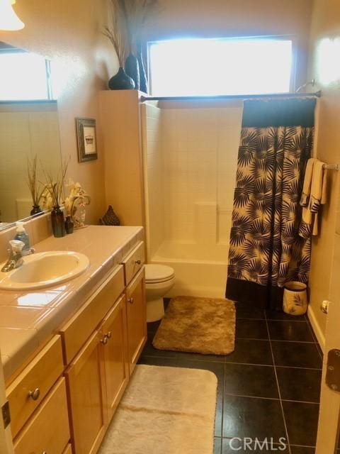 full bathroom featuring vanity, tile patterned flooring, shower / tub combo with curtain, and toilet