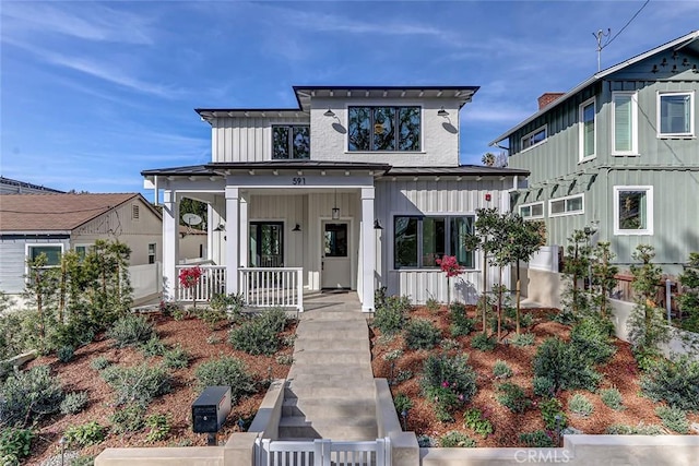 view of front facade featuring board and batten siding and covered porch