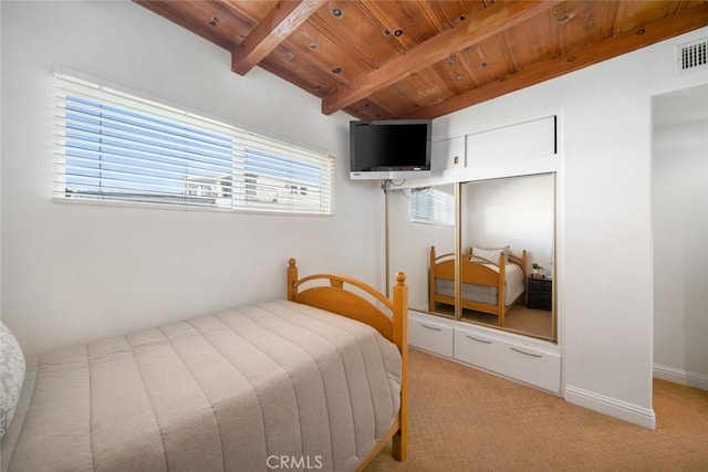 bedroom with vaulted ceiling with beams, light carpet, a closet, and wooden ceiling