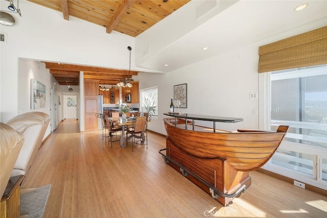 interior space featuring hanging light fixtures, wood ceiling, light hardwood / wood-style flooring, high vaulted ceiling, and beamed ceiling