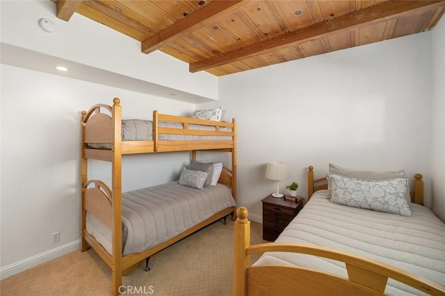 bedroom featuring carpet, beamed ceiling, and wooden ceiling