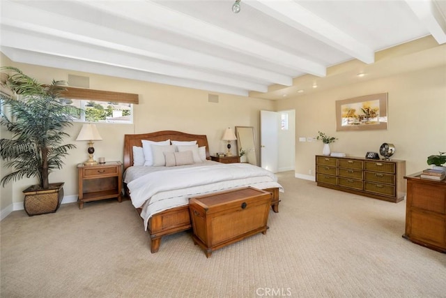 carpeted bedroom featuring beamed ceiling