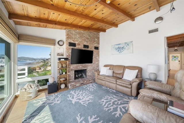 living room with a brick fireplace, hardwood / wood-style flooring, beamed ceiling, and wood ceiling