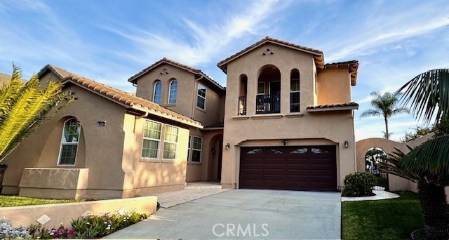 mediterranean / spanish house featuring a garage