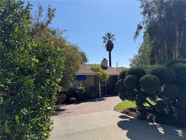 obstructed view of property with a chimney