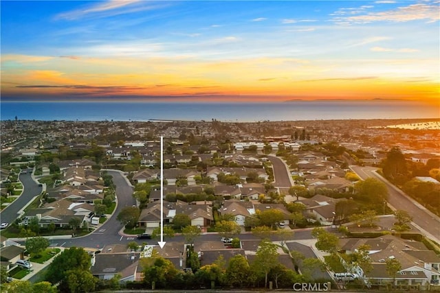 aerial view at dusk with a water view