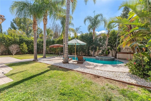 view of swimming pool featuring a patio area, a yard, and an in ground hot tub