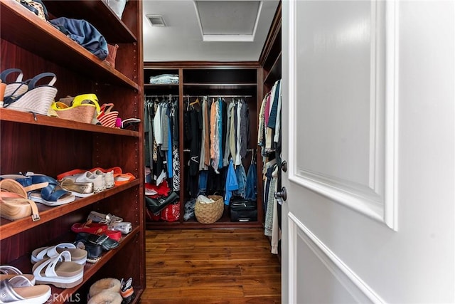 spacious closet featuring dark hardwood / wood-style floors