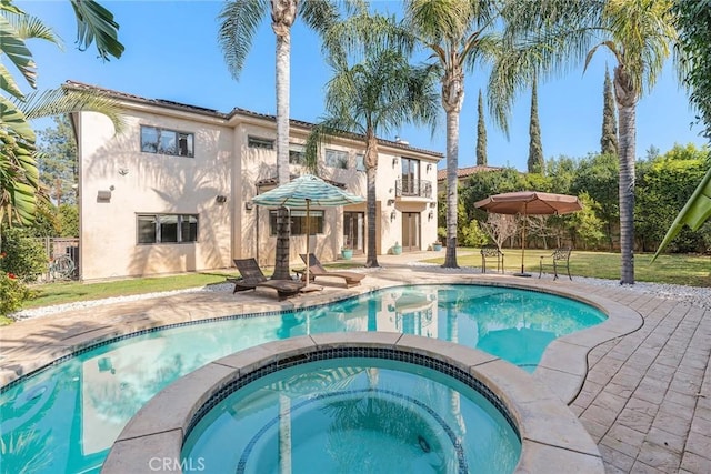 view of swimming pool featuring a patio and an in ground hot tub