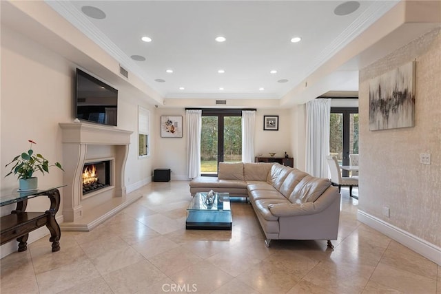 living room with a premium fireplace, french doors, and crown molding