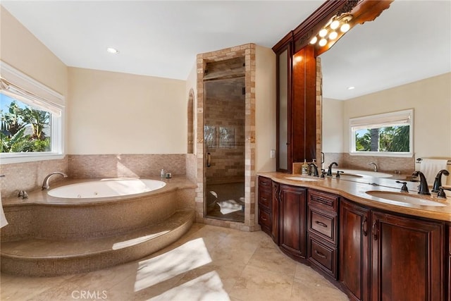 bathroom featuring shower with separate bathtub, tile patterned flooring, and vanity