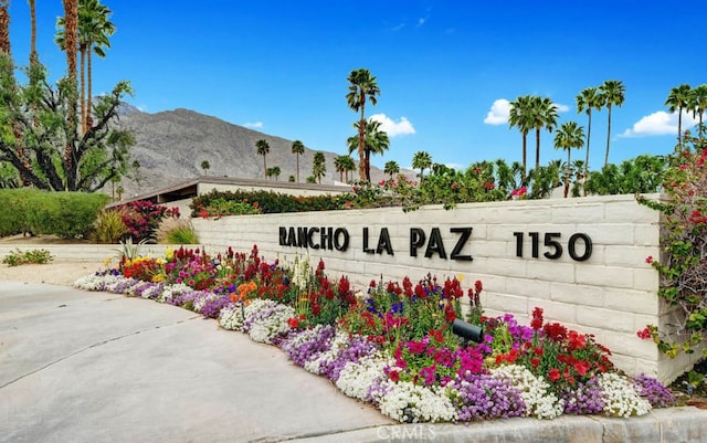 community sign with a mountain view