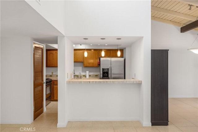 1150 E Palm Canyon Dr Unit 51, Palm Springs, CA 92264 - kitchen featuring stainless steel fridge with ice dispenser, range with gas cooktop, brown cabinetry, light countertops, and a towering ceiling