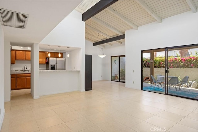 1150 E Palm Canyon Dr Unit 51, Palm Springs, CA 92264 - unfurnished living room with high vaulted ceiling, a sink, beamed ceiling, and light tile patterned floors
