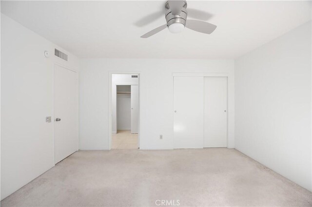 1150 E Palm Canyon Dr Unit 51, Palm Springs, CA 92264 - unfurnished bedroom with light carpet, ceiling fan, and multiple closets